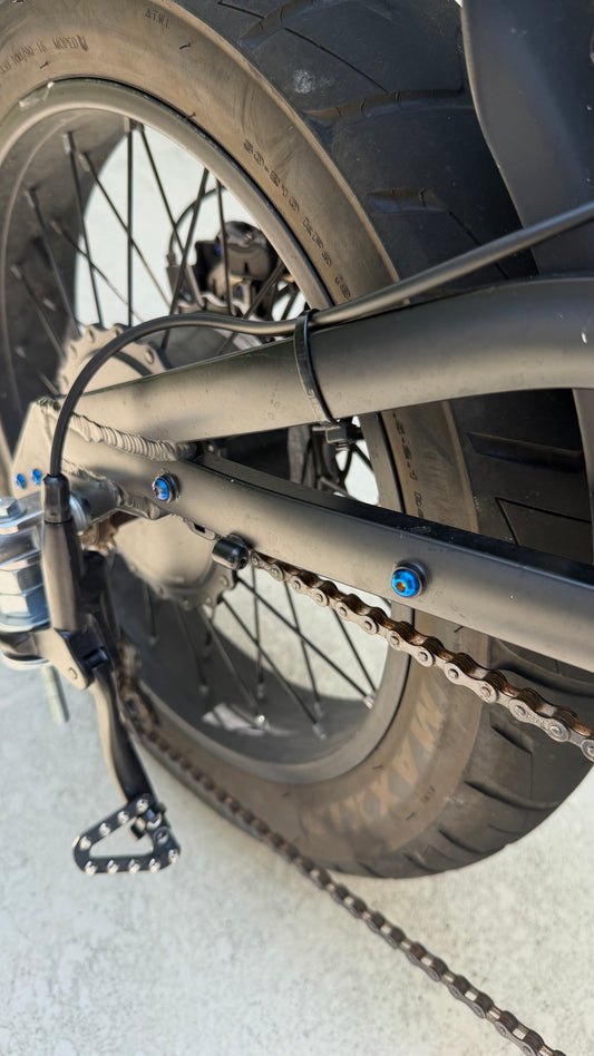 Close-up of a bicycle chain and gear system on a light background