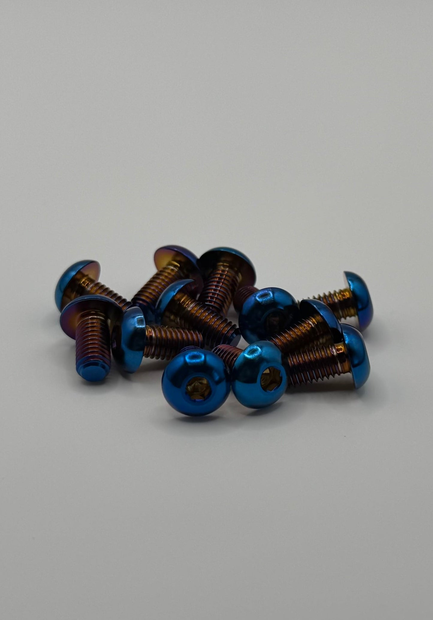 Collection of small blue screws on a gray background