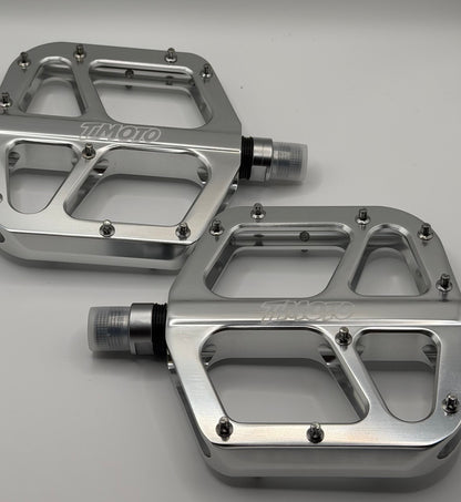 close up of left and right Timoto chrome pedals