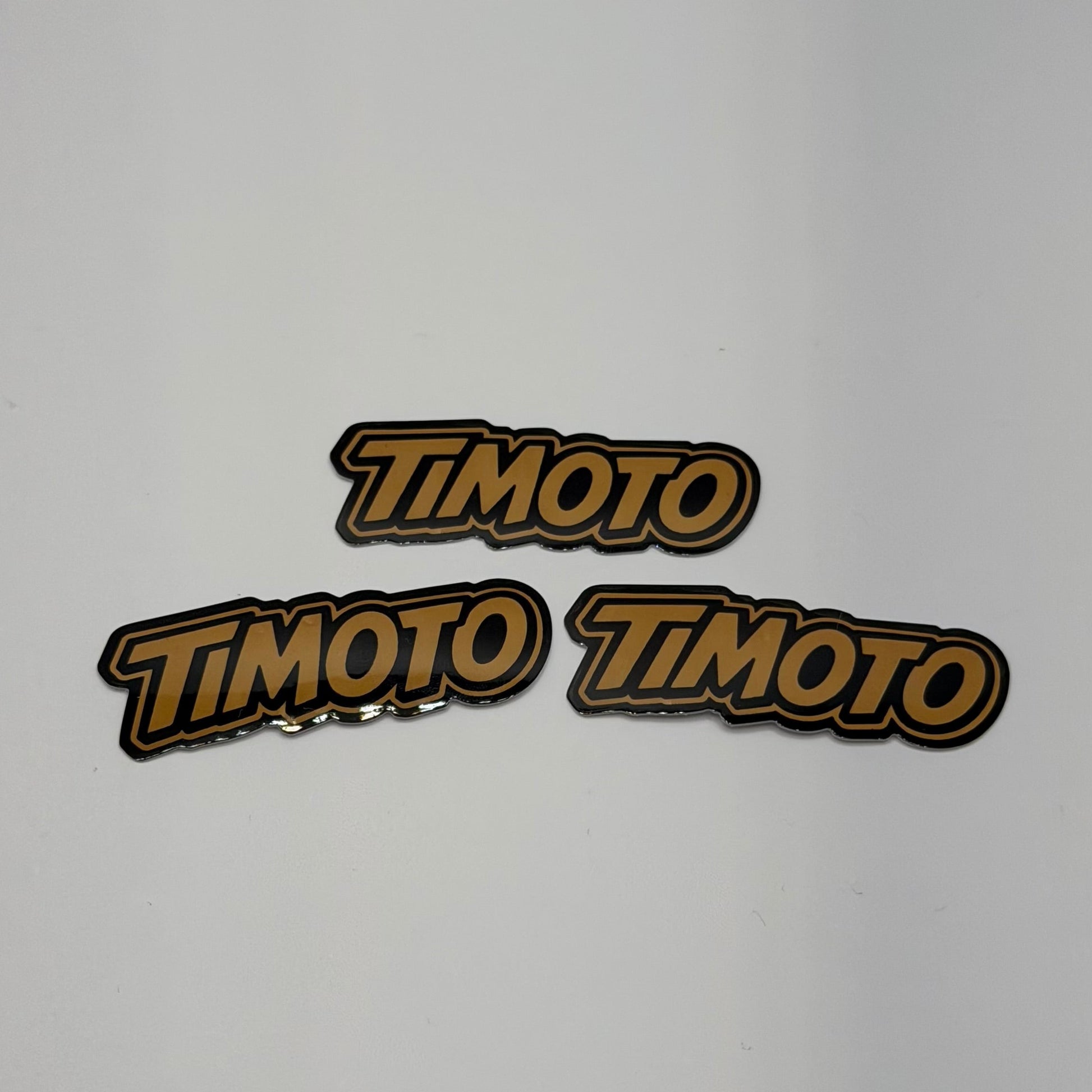 Three 'TIMOTO' logos on a light gray background