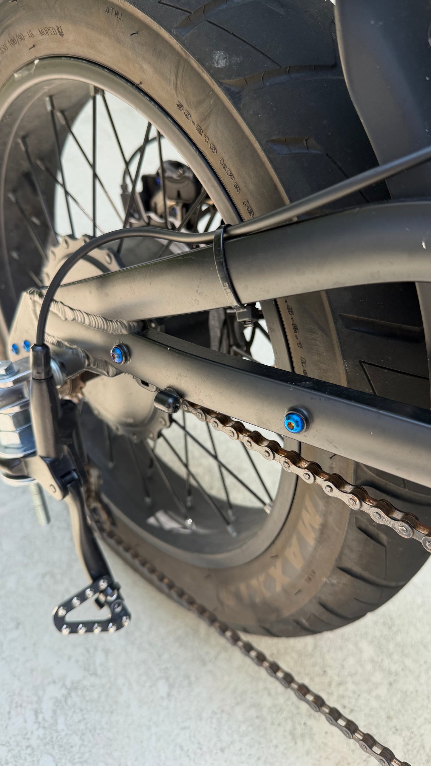 Close-up of a bicycle chain and gear system on a light background