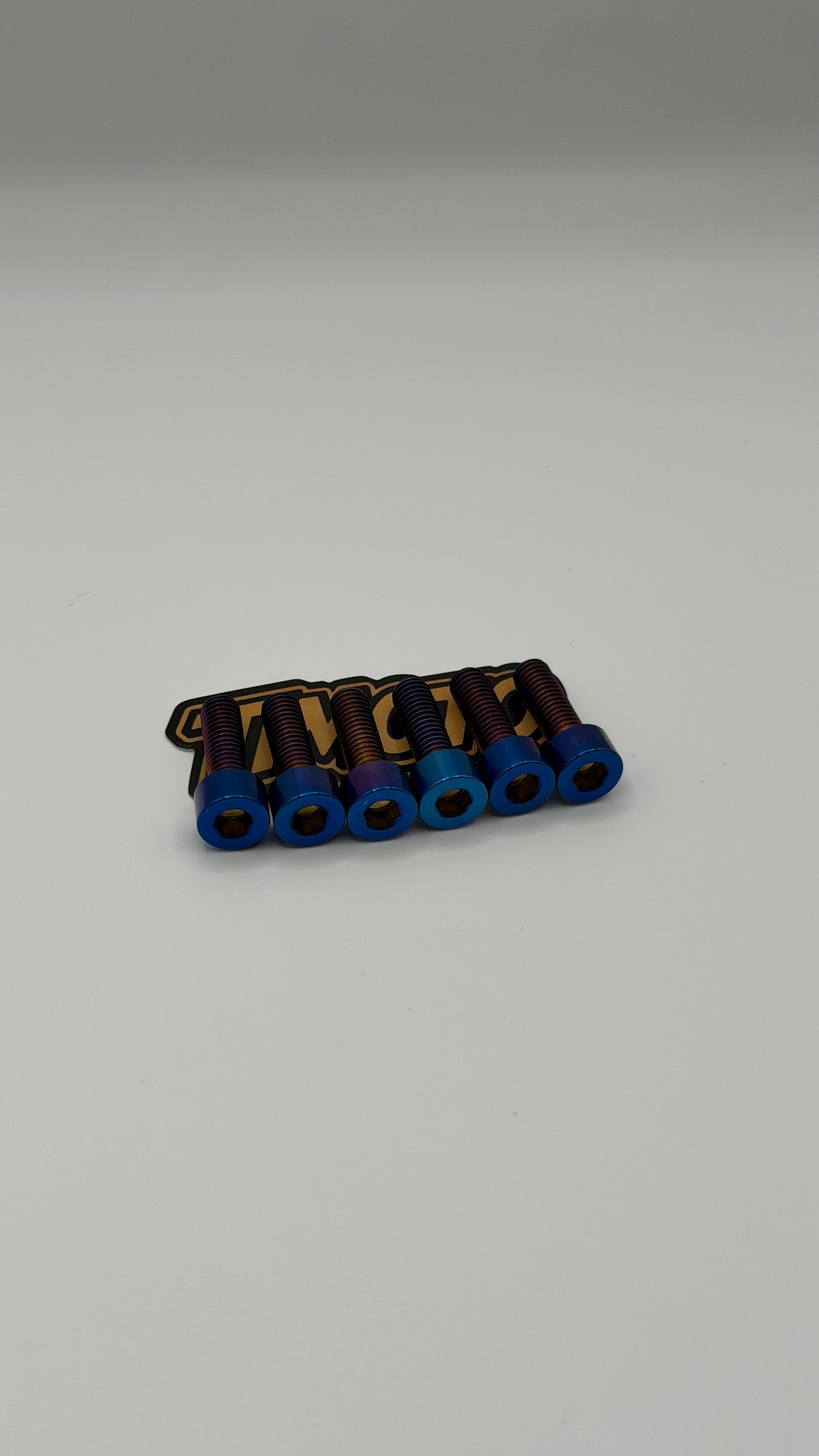 Set of metal components with blue and gold accents on a gray background