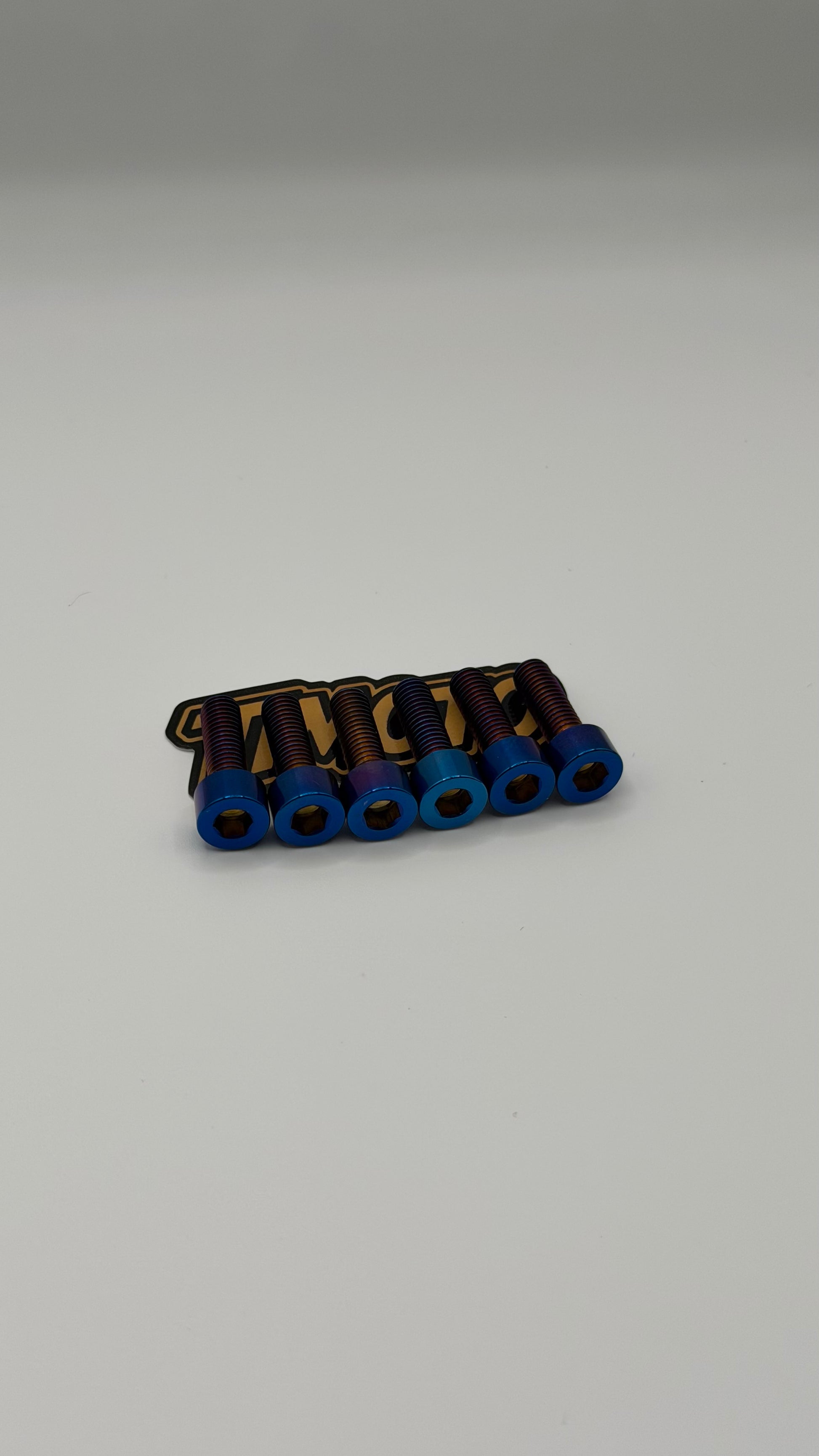 Set of metal components with blue and gold accents on a gray background
