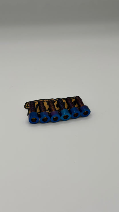 Set of metal components with blue and gold accents on a gray background