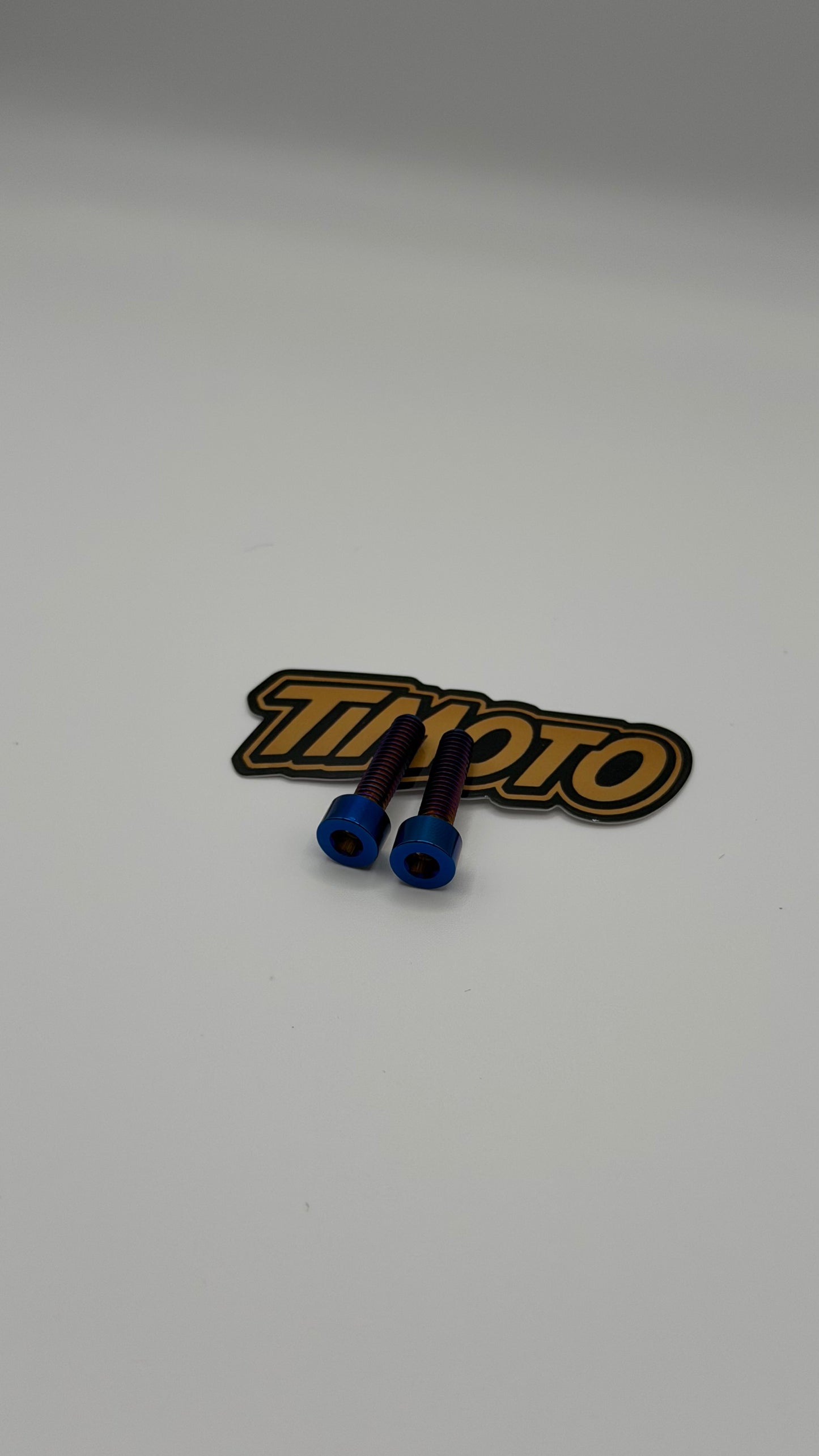 Two blue connectors on a timoto logo patch against a white background