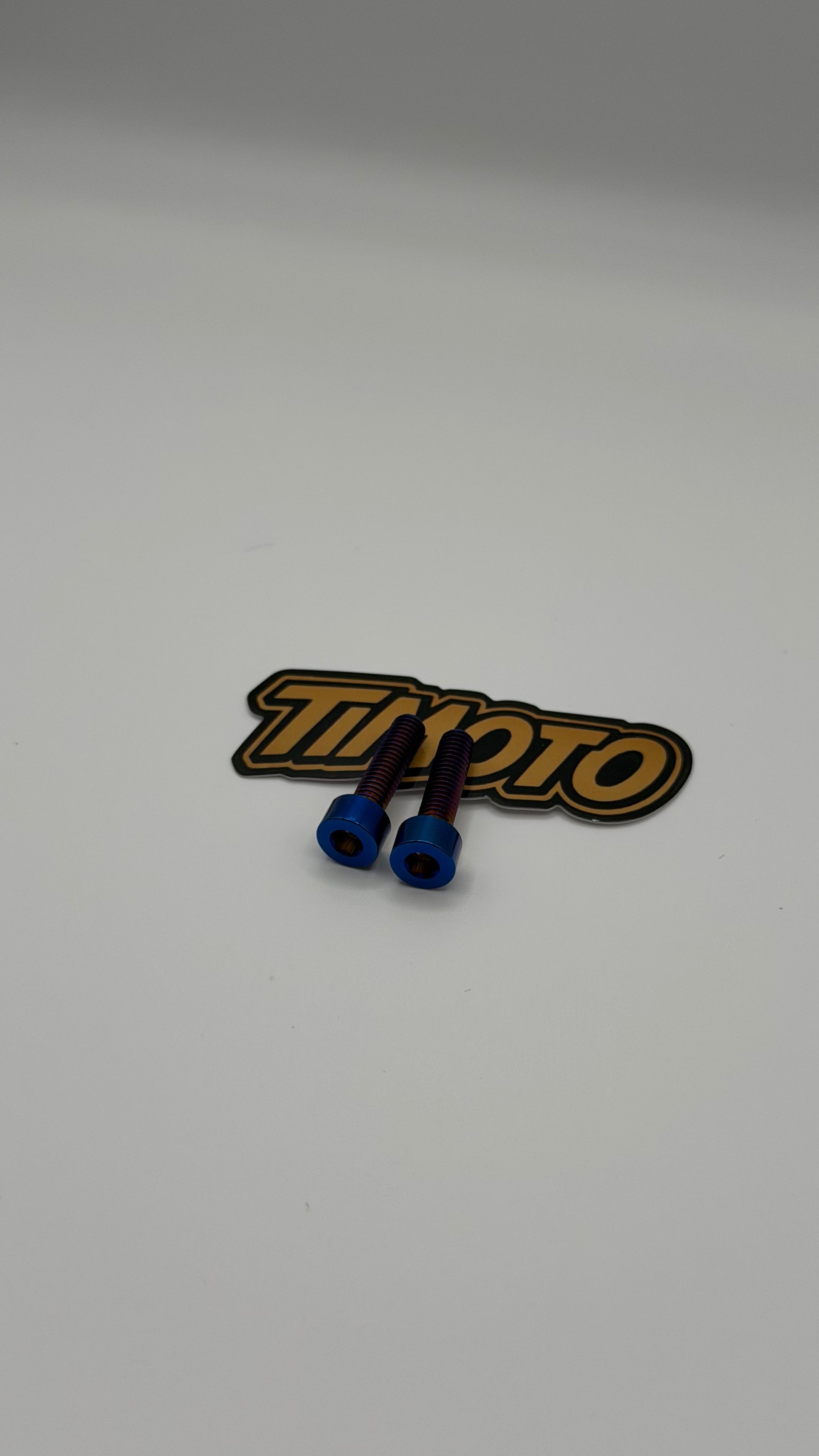 Two blue connectors on a timoto logo patch against a white background