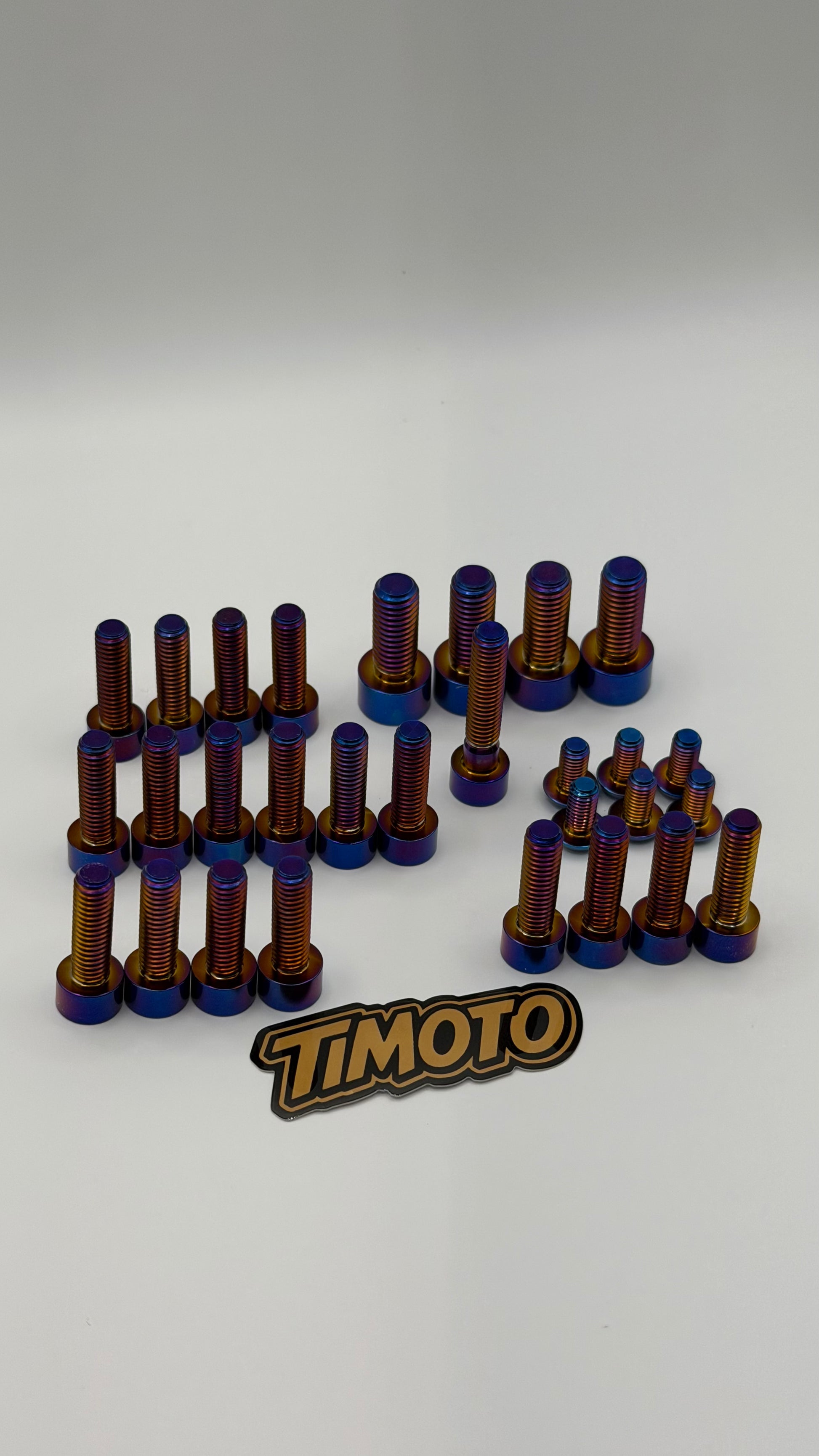 Set of metal bolts with blue and brown colors on a white background, featuring the 'Timoto' brand logo.