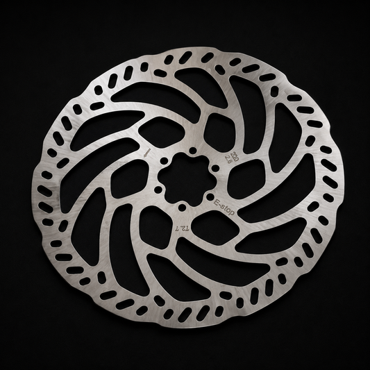 Metallic bike disc brake rotor on a black background